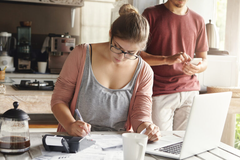 Woman calculating possible household expenses.